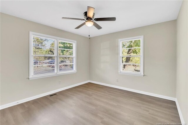 7517 Seaton Pl, Fayetteville, NC 28303 - empty room featuring ceiling fan, visible vents, baseboards, and wood finished floors