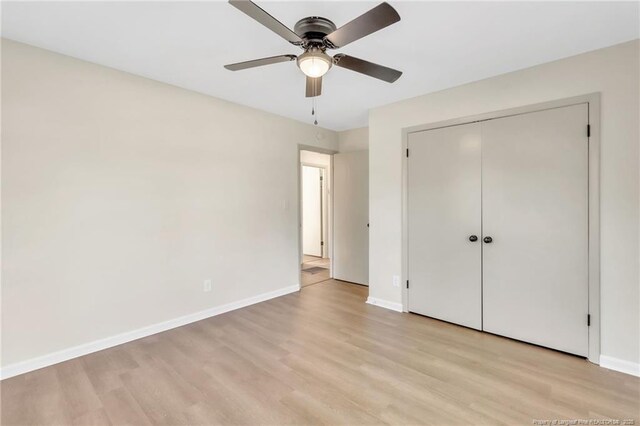 7517 Seaton Pl, Fayetteville, NC 28303 - unfurnished bedroom featuring a closet, light wood finished floors, baseboards, and a ceiling fan