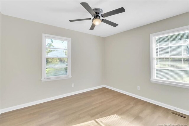 7517 Seaton Pl, Fayetteville, NC 28303 - empty room with ceiling fan, visible vents, baseboards, and wood finished floors