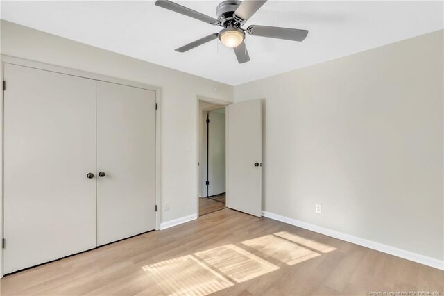 7517 Seaton Pl, Fayetteville, NC 28303 - unfurnished bedroom with a closet, light wood-style flooring, ceiling fan, and baseboards