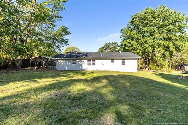 7517 Seaton Pl, Fayetteville, NC 28303 - back of house featuring a detached carport and a lawn