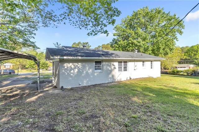 7517 Seaton Pl, Fayetteville, NC 28303 - rear view of house with a yard and a detached carport