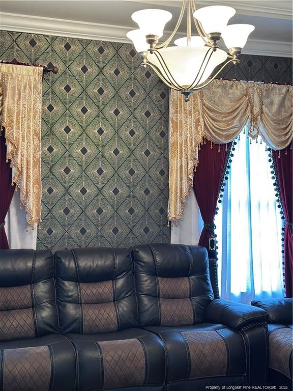living room featuring ornamental molding, plenty of natural light, and a chandelier