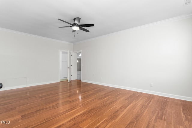 spare room with baseboards, ornamental molding, ceiling fan, and wood finished floors