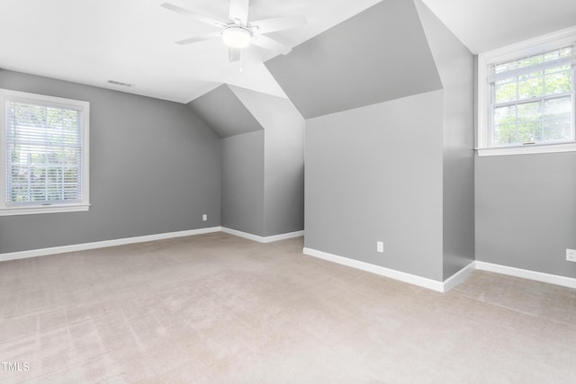 bonus room featuring a ceiling fan, baseboards, light carpet, and lofted ceiling