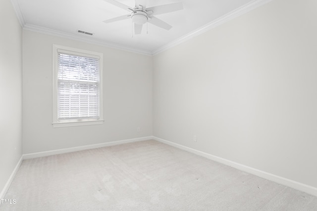unfurnished room featuring crown molding, baseboards, visible vents, and carpet floors