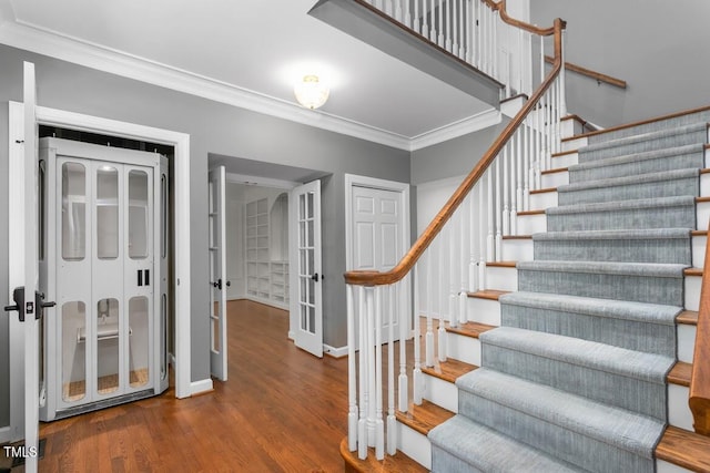 stairway featuring baseboards, ornamental molding, french doors, and wood finished floors