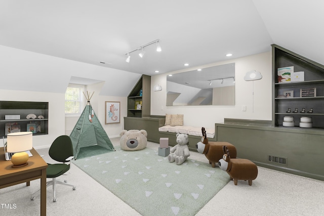 rec room featuring rail lighting, visible vents, built in features, and carpet