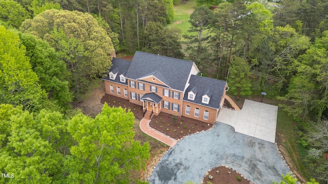 birds eye view of property featuring a view of trees