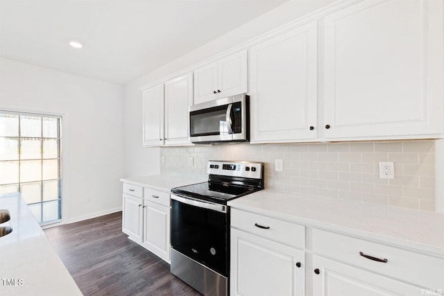 kitchen featuring appliances with stainless steel finishes, decorative backsplash, light countertops, and white cabinetry