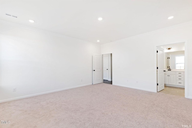 unfurnished bedroom featuring ornamental molding, visible vents, baseboards, and light colored carpet