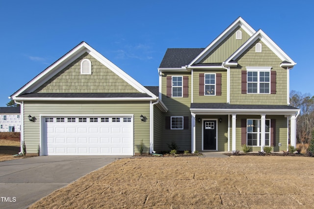 craftsman-style house with a porch, a garage, and driveway
