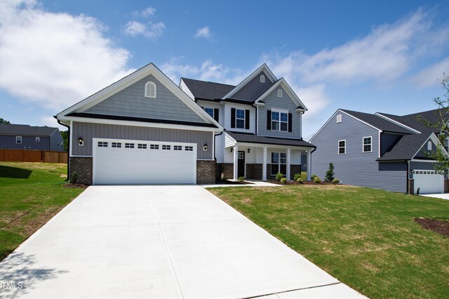 40 Rosewood Ln, Youngsville, NC 27596 - craftsman inspired home with board and batten siding, brick siding, concrete driveway, and an attached garage