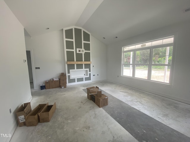 102 Rae Dr, Pikeville, NC 27863 - unfurnished living room featuring vaulted ceiling and baseboards