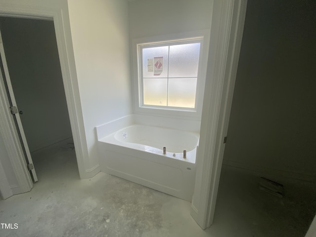 102 Rae Dr, Pikeville, NC 27863 - bathroom featuring a garden tub and concrete floors