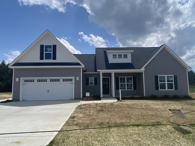 102 Rae Dr, Pikeville, NC 27863 - view of front of house with driveway, a porch, and a shingled roof