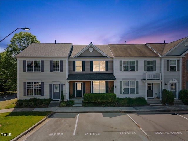 townhome / multi-family property featuring uncovered parking