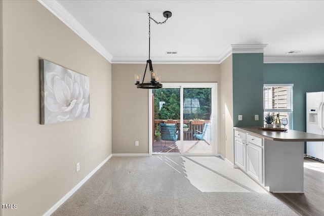 unfurnished dining area featuring crown molding, baseboards, an inviting chandelier, and visible vents