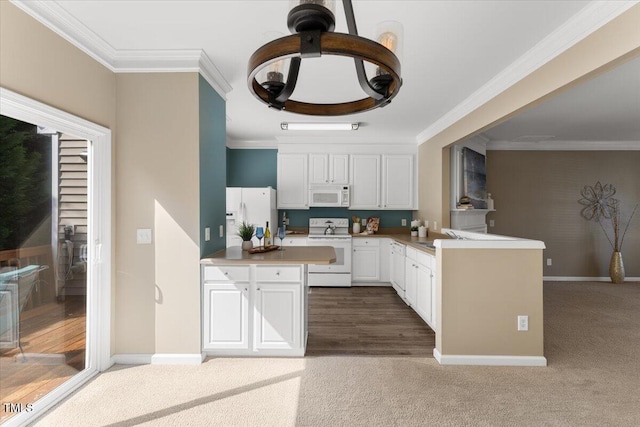 kitchen with white appliances, a peninsula, and crown molding