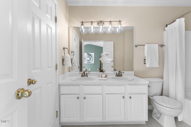 bathroom with a sink, a shower with curtain, toilet, and double vanity