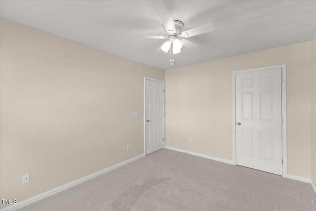unfurnished room featuring baseboards, ceiling fan, and carpet