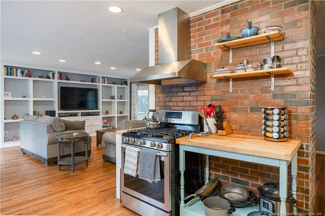 211 Edgewood Ave, Clinton, NC 28328 - kitchen featuring wall chimney exhaust hood, a textured ceiling, recessed lighting, gas range, and light wood finished floors