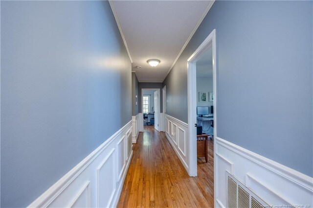 211 Edgewood Ave, Clinton, NC 28328 - corridor with a decorative wall, ornamental molding, wainscoting, and wood finished floors