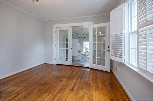 211 Edgewood Ave, Clinton, NC 28328 - unfurnished room featuring a chandelier, french doors, baseboards, and hardwood / wood-style floors