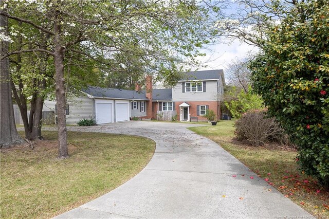 211 Edgewood Ave, Clinton, NC 28328 - view of front facade with a garage, driveway, a front lawn, and brick siding
