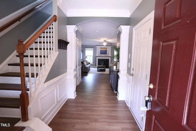 126 Willow Weald Ct, Fuquay Varina, NC 27526 - entrance foyer featuring a decorative wall, a ceiling fan, dark wood-style floors, arched walkways, and stairs