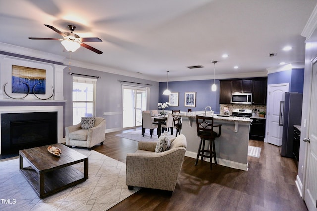126 Willow Weald Ct, Fuquay Varina, NC 27526 - living room featuring a fireplace, ornamental molding, dark wood-type flooring, recessed lighting, and a ceiling fan