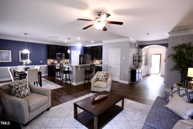 126 Willow Weald Ct, Fuquay Varina, NC 27526 - living area with arched walkways, a ceiling fan, ornamental molding, light wood-style floors, and recessed lighting