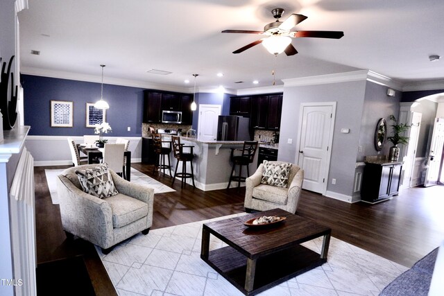 126 Willow Weald Ct, Fuquay Varina, NC 27526 - living area featuring a ceiling fan, arched walkways, ornamental molding, wood finished floors, and baseboards