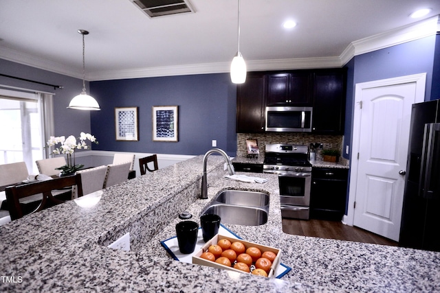 126 Willow Weald Ct, Fuquay Varina, NC 27526 - kitchen with stainless steel appliances, a sink, crown molding, dark wood-type flooring, and backsplash