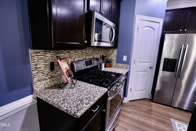 126 Willow Weald Ct, Fuquay Varina, NC 27526 - kitchen with stainless steel appliances, wood finished floors, decorative backsplash, and light stone countertops