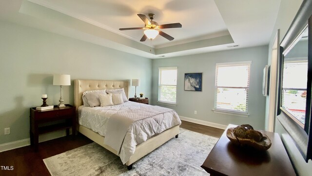 126 Willow Weald Ct, Fuquay Varina, NC 27526 - bedroom featuring a tray ceiling, ornamental molding, dark wood-style floors, baseboards, and ceiling fan