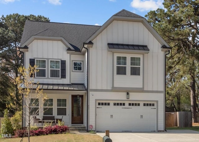 view of front of home featuring a standing seam roof, fence, board and batten siding, and metal roof