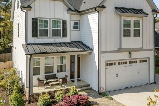 modern farmhouse style home featuring board and batten siding, a standing seam roof, and metal roof