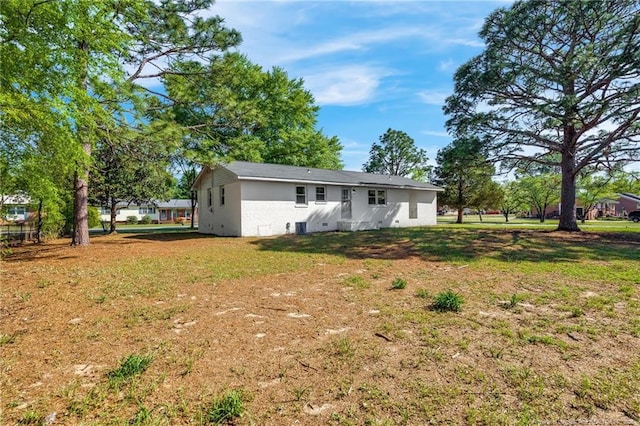 3014 Akron Dr, Hope Mills, NC 28348 - back of house featuring a yard and stucco siding