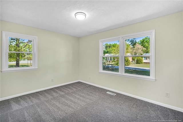 3014 Akron Dr, Hope Mills, NC 28348 - empty room with visible vents, baseboards, a textured ceiling, and carpet floors