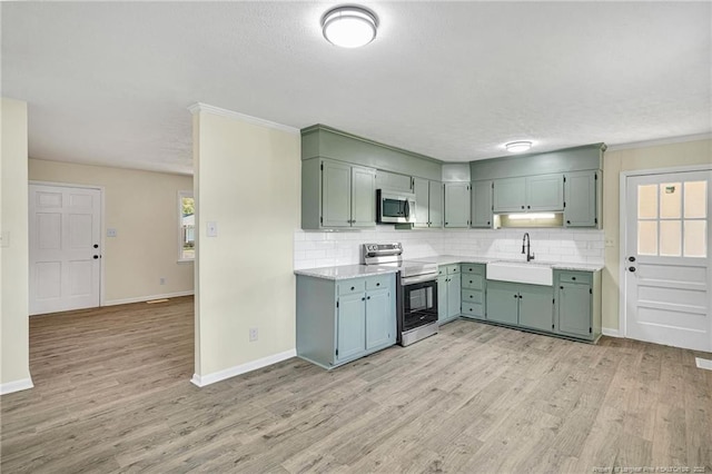 3014 Akron Dr, Hope Mills, NC 28348 - kitchen with a sink, tasteful backsplash, light countertops, and appliances with stainless steel finishes