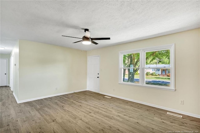 3014 Akron Dr, Hope Mills, NC 28348 - empty room featuring visible vents, baseboards, a ceiling fan, and wood finished floors