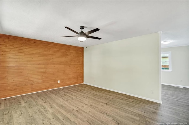 3014 Akron Dr, Hope Mills, NC 28348 - unfurnished room with wood walls, ceiling fan, wood finished floors, and baseboards