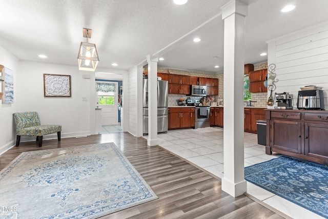 2102 Courtland Dr, Sanford, NC 27330 - entryway featuring recessed lighting, light wood finished floors, and ornate columns