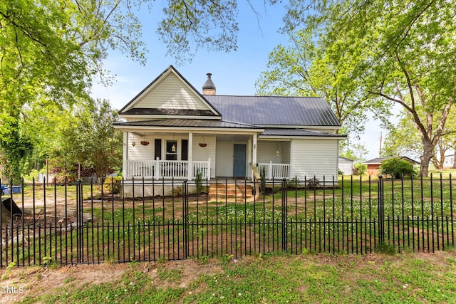 2102 Courtland Dr, Sanford, NC 27330 - view of front of property featuring metal roof, a fenced front yard, and covered porch