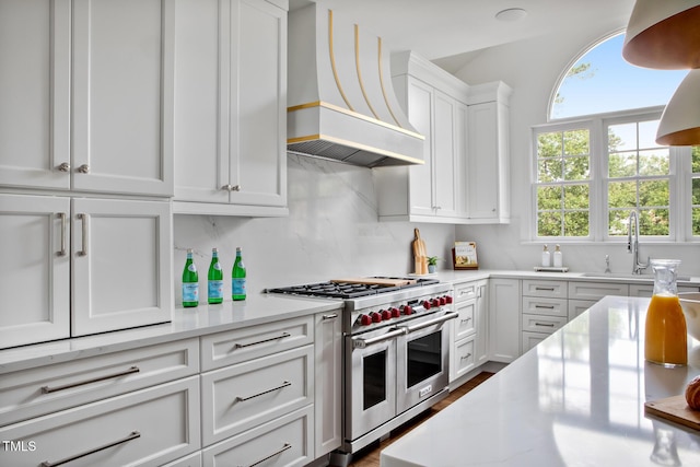123 Trellingwood Dr, Morrisville, NC 27560 - kitchen with custom range hood, double oven range, light countertops, and white cabinets