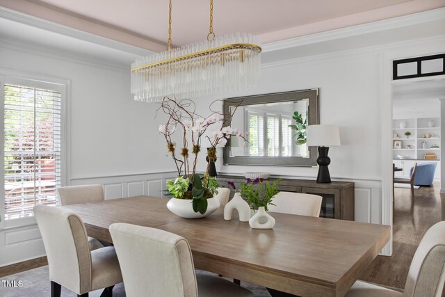 123 Trellingwood Dr, Morrisville, NC 27560 - dining space featuring a decorative wall, crown molding, healthy amount of natural light, wood finished floors, and wainscoting
