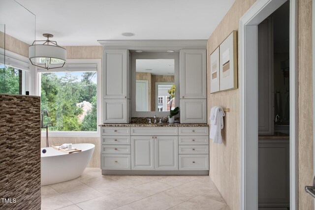 123 Trellingwood Dr, Morrisville, NC 27560 - bathroom with a freestanding tub, vanity, a chandelier, and tile patterned floors