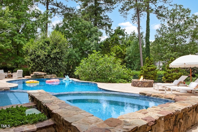 123 Trellingwood Dr, Morrisville, NC 27560 - view of pool with an outdoor fire pit, a pool with connected hot tub, a patio, and view of scattered trees