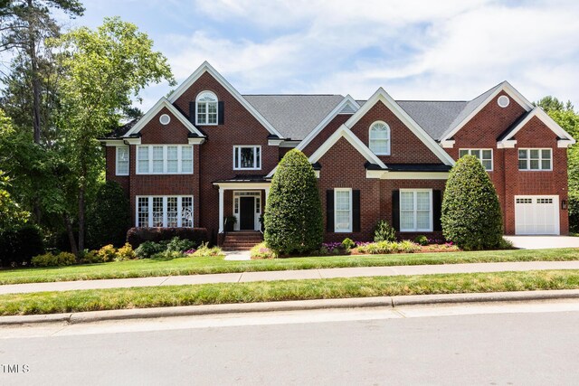 123 Trellingwood Dr, Morrisville, NC 27560 - view of front of home with brick siding and an attached garage
